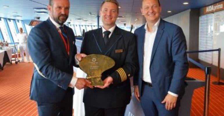 Dirk Claus, at left, AIDAprima Capt. Marc-Dominique Tidow and Felix Eichhorn for the plaque and key ceremony at Kiel on Friday